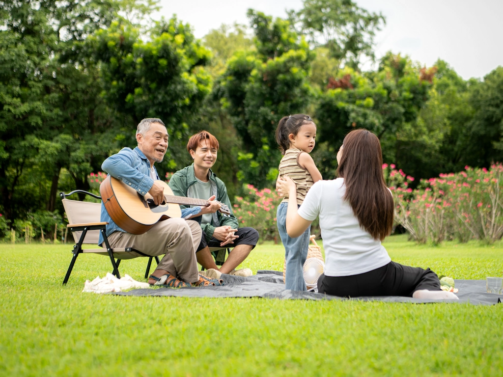 Happy multi-generational Asian family enjoying a picnic