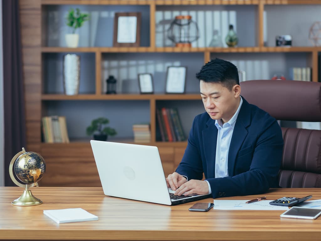 Young handsome Asian businessman and lawyer at work