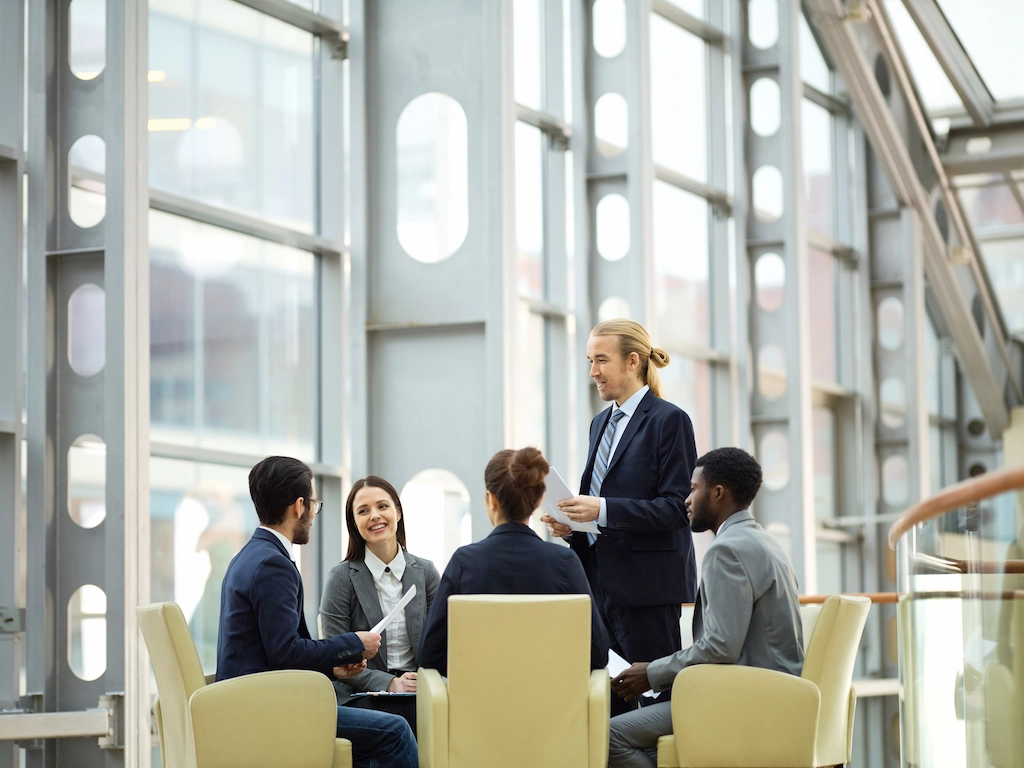 Professionals gather for a meeting in a modern building