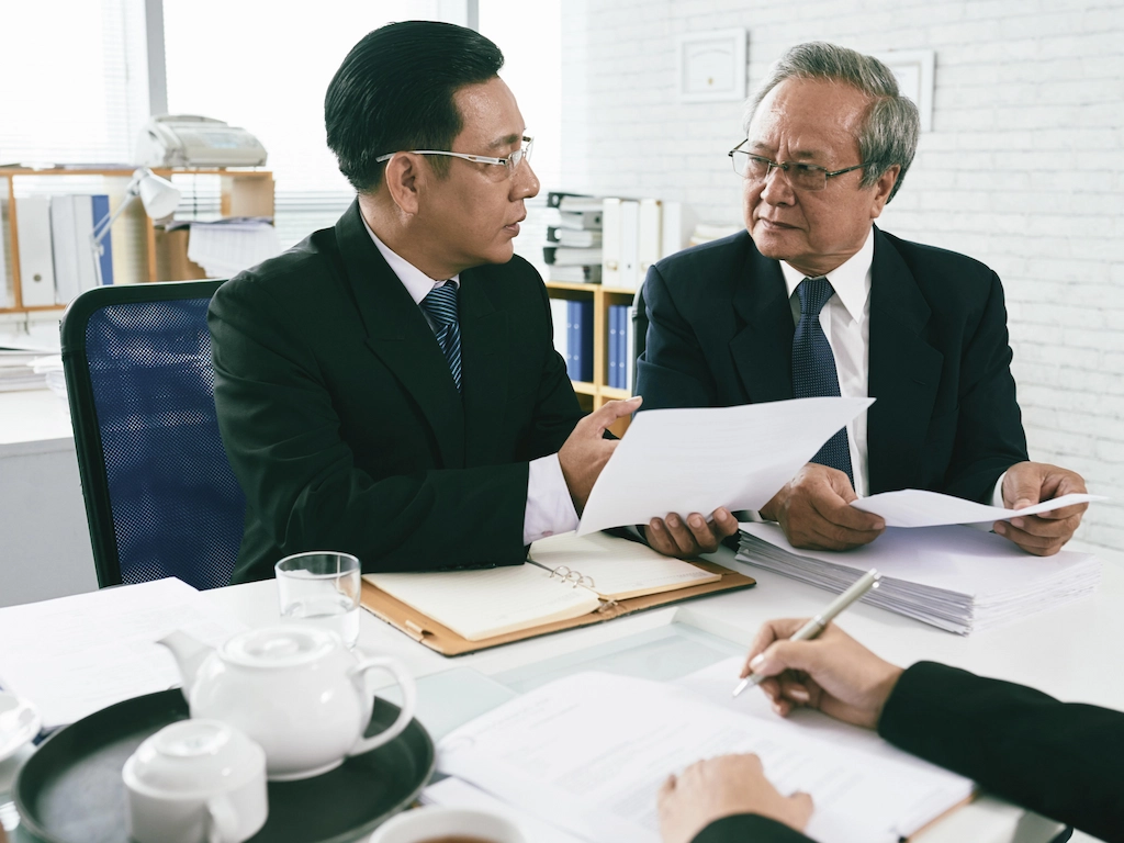 Business meeting between colleagues discussing documents