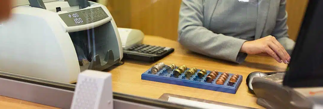 In front of a teller at a bank