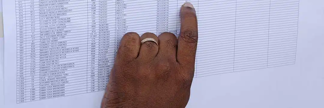 A hand examining a list