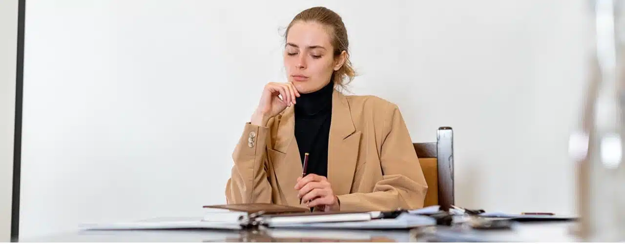 A woman preparing documents to open Treasurer in Trust Account or TITF.