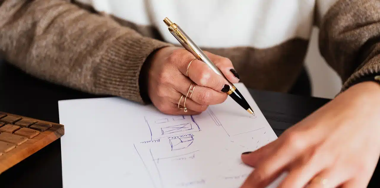 A photo of a man sketching the location of his house on a piece of paper as part of his Sworn Certificate of Residency. This may be needed for an Annulment case in the Philippines
