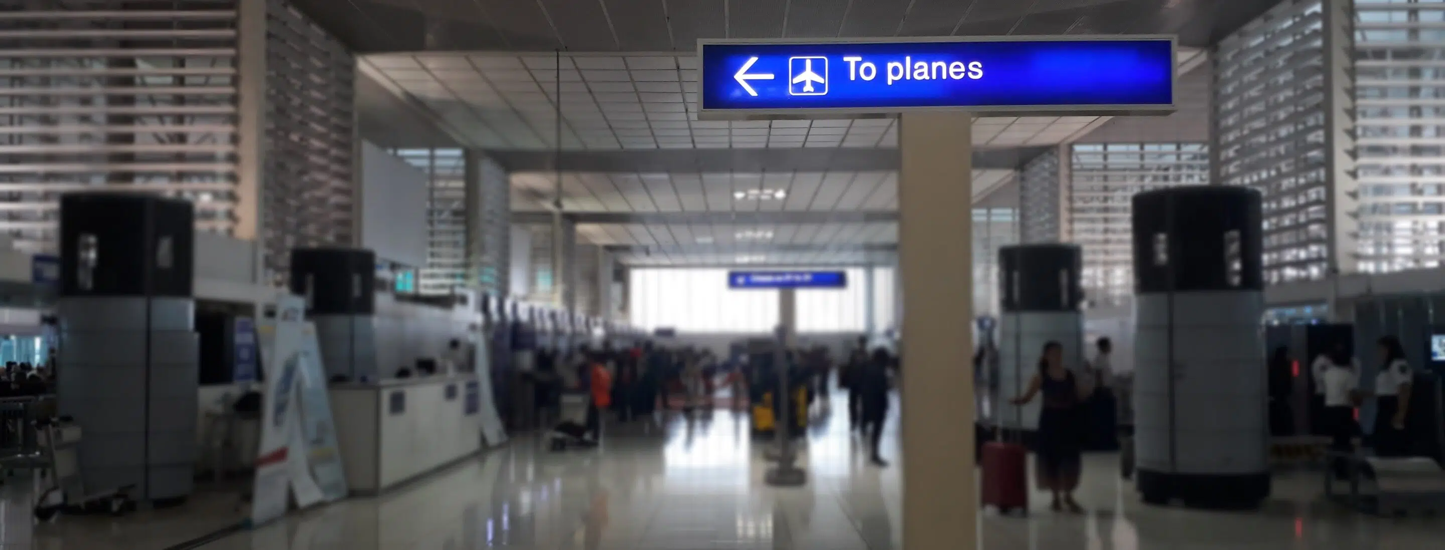 An airport terminal with a sign