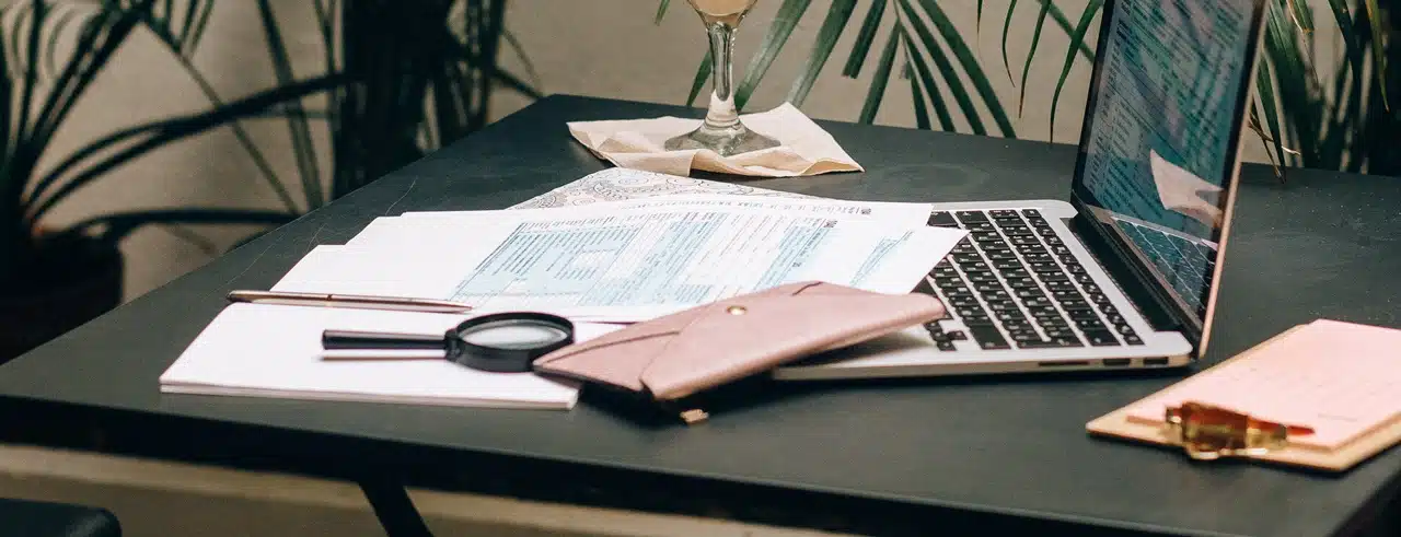 TITF corporate bank account requirements Philippines on the table alongside a laptop.