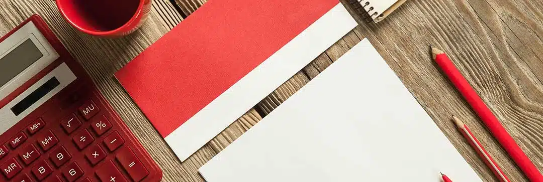 A piece of paper next to a red calculator, mug and pencil to symbolize calculating costs. Recognition of Foreign Divorce in Philippines cost