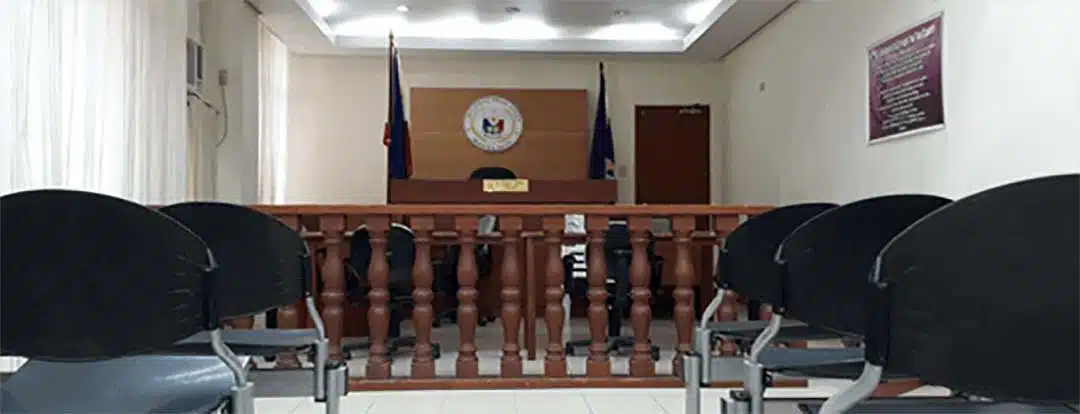 A photo of a Philippine Regional Trial Court, with rows of chairs, a wooden partition and the Judges desk and chair at the front.   How to file Recognition of Foreign Divorce in the Philippines