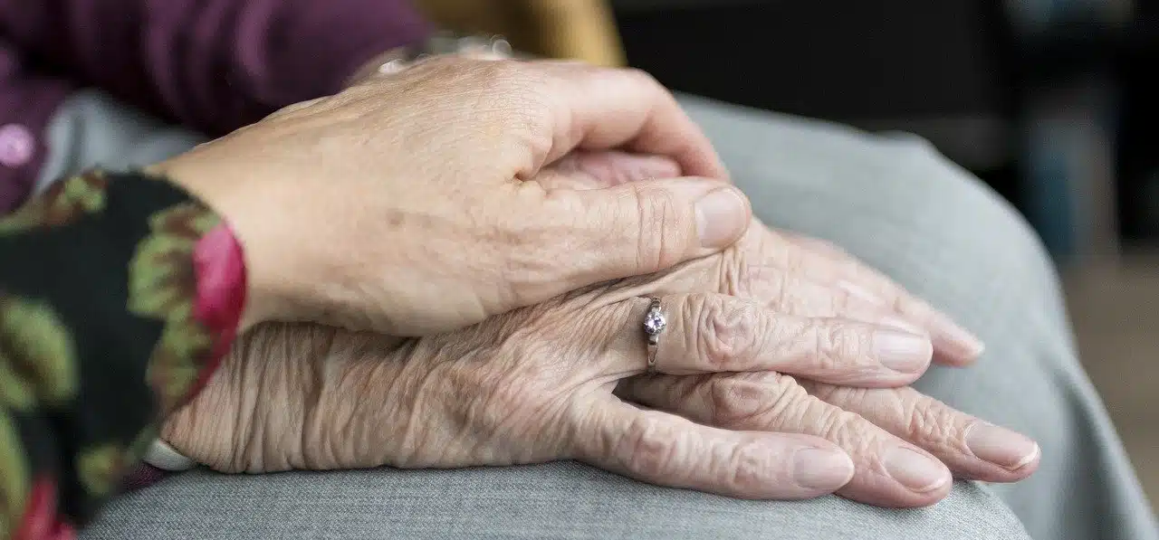 An old couple holding hands
